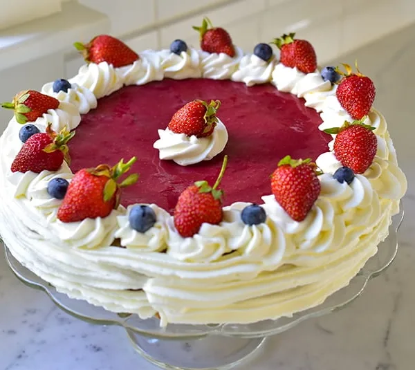 Strawberry Cake with Whipped Cream on a cake stand