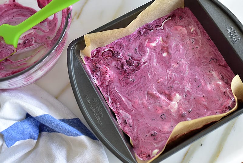 Blueberry yogurt swirl in a pan with parchment lining