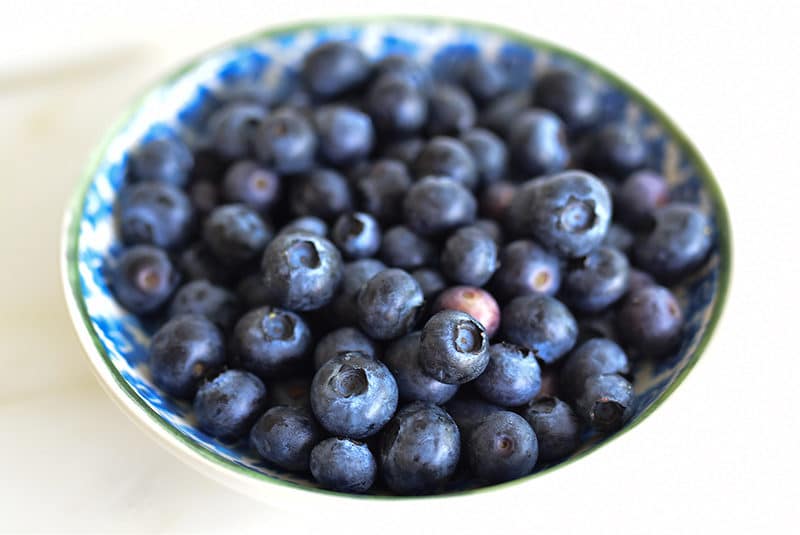 Blueberries in a green and blue dish