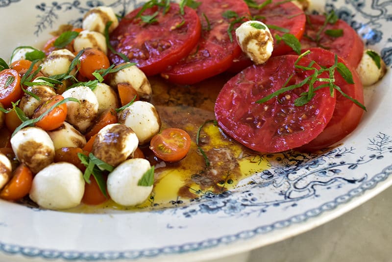 Olive oil in the bottom of a platter of tomatoes