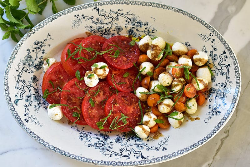 Caprese salad on a blue platter