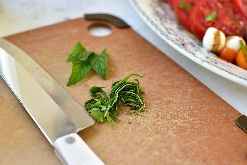 Mint leaves on a cutting board with a knife