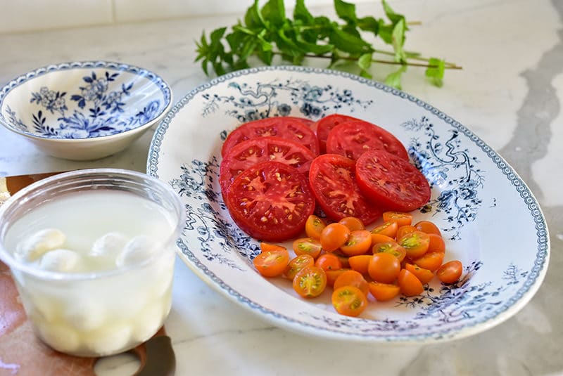 Tomato slices and cherry tomatoes on a platter