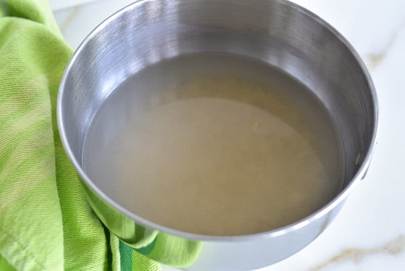 Rice with water in a metal bowl