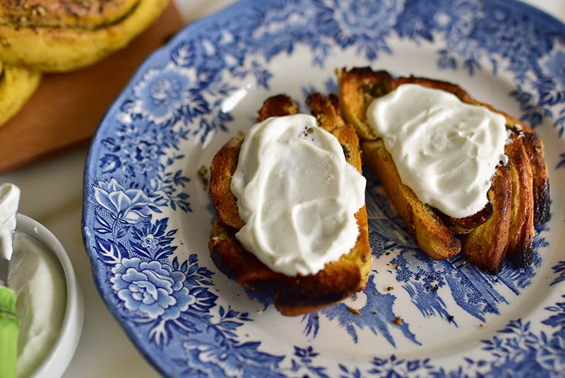 Slices of toast with labneh on a blue plate