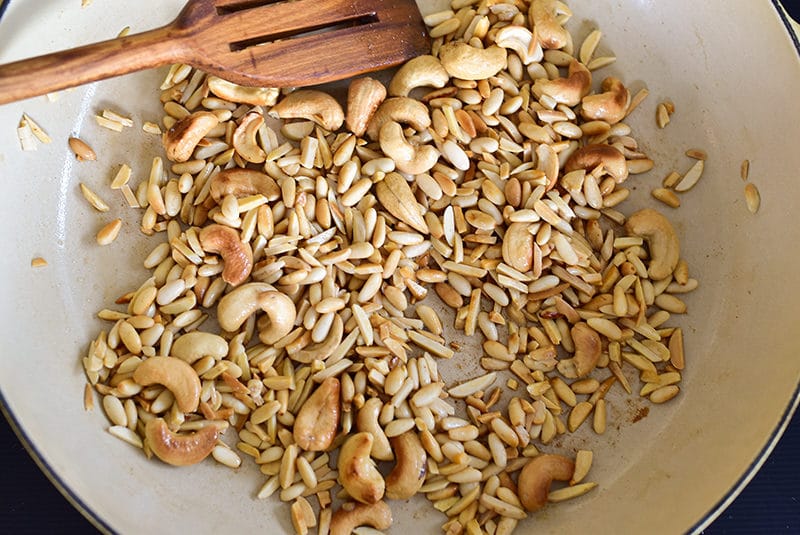 Nuts in a pan with a wooden spoon