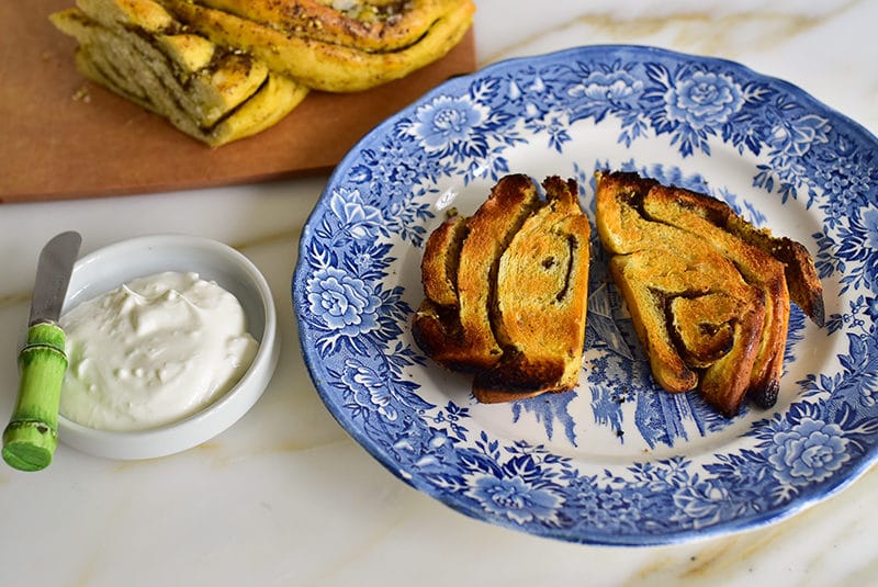 Toasted pieces of za'atar swirl bread with a bowl of labneh