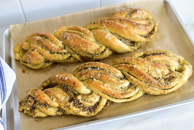 Two loaves of twisted bread on a sheet pan