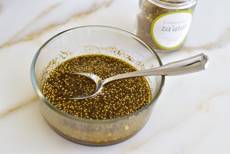 Zaatar and olive oil in a bowl with a spoon