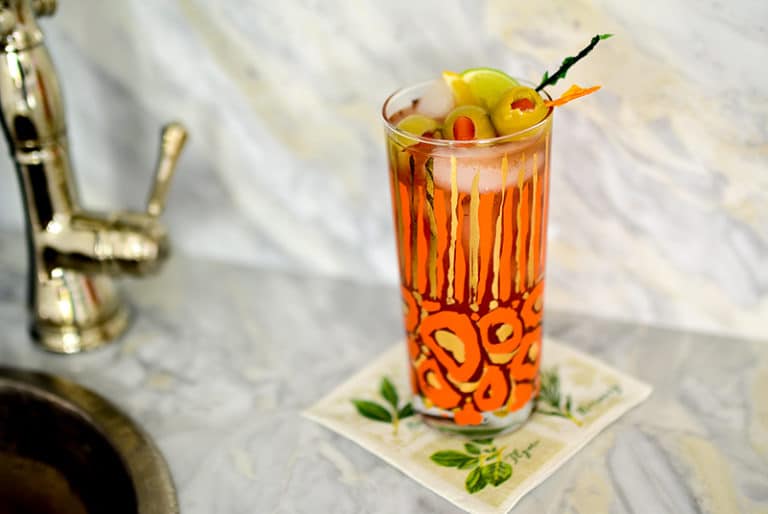 Bloody Mary cocktail on the bar in an orange and gold glass