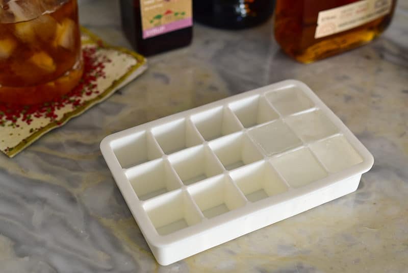 Square ice cube tray on a marble bar