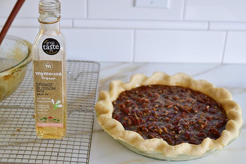 Pecan pie with a bottle of Mymoune Orange Blossom Water