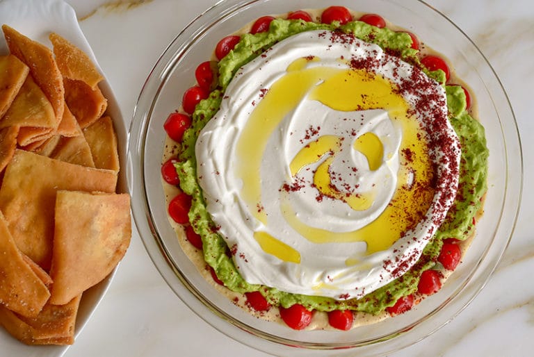 7 layer dip Mediterranean style in a pie plate