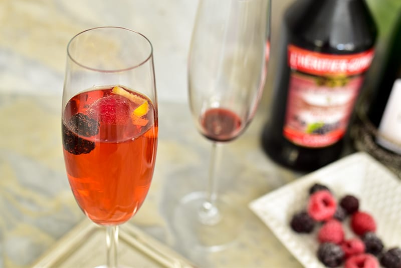 Kir Royale with frozen berries