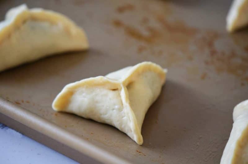 Spinach pies on a baking sheet