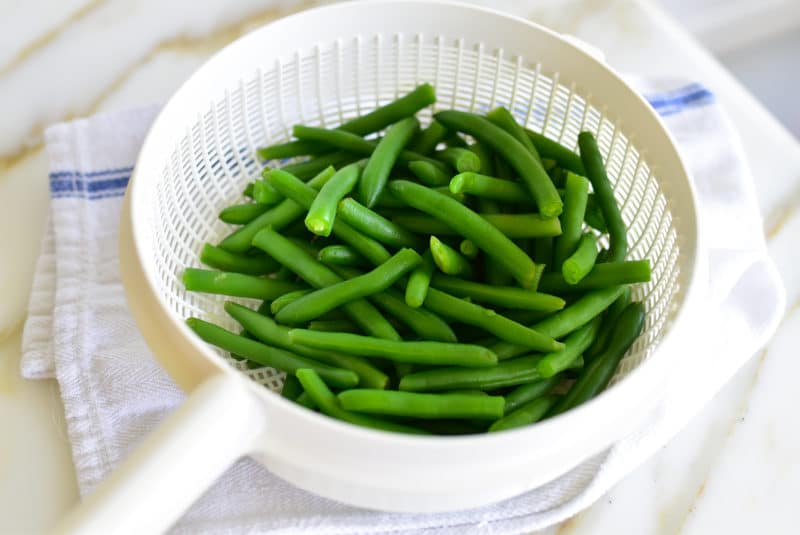 Green beans in a white colander