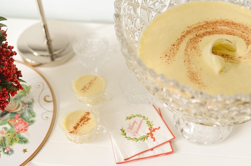 Eggnog in crystal cups with cinnamon and Christmas napkins