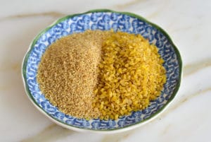 Fine and coarse bulgur side by side in a blue bowl