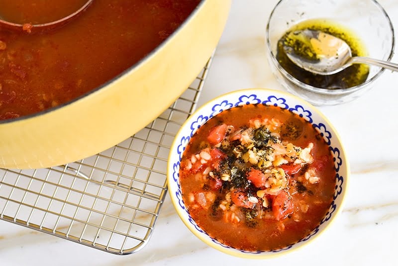 Lentil bulgur tomato soup in a bowl with yellow pot