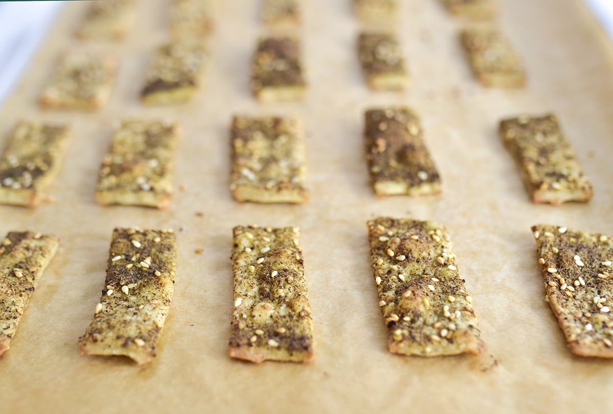 homemade crackers on parchment paper with za'atar topping