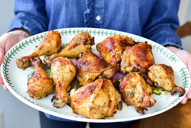 7 Spice chicken on a platter held in hands