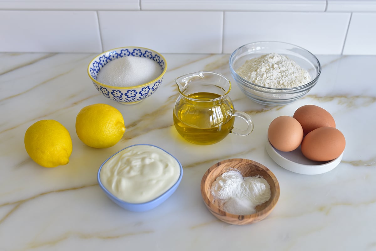 Ingredients for olive oil cake on a marble countertop