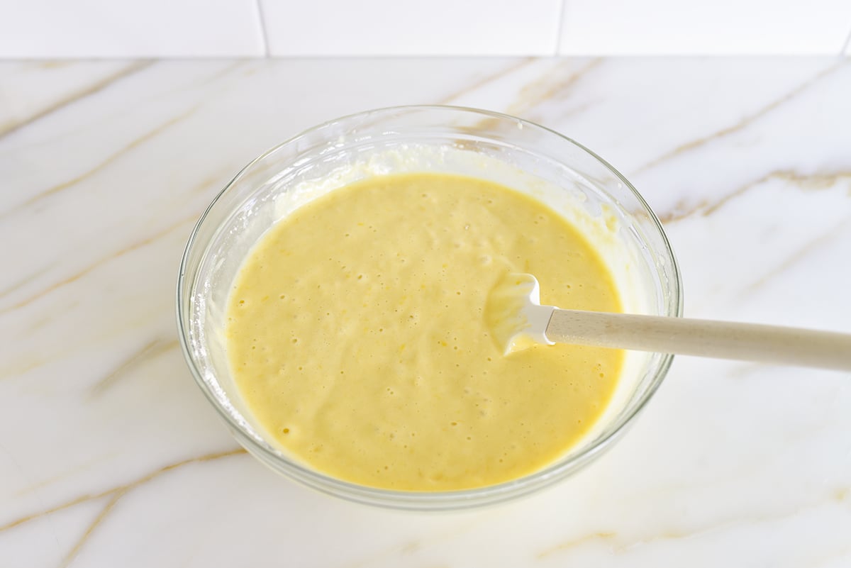 Yellow cake batter in a bowl with a spatula
