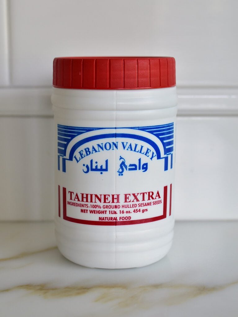 Lebanon Valley Tahini jar with a red lid on a marble countertop