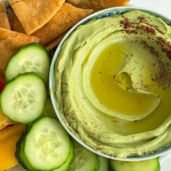 Avocado hummus with olive oil and sumac in a round dish