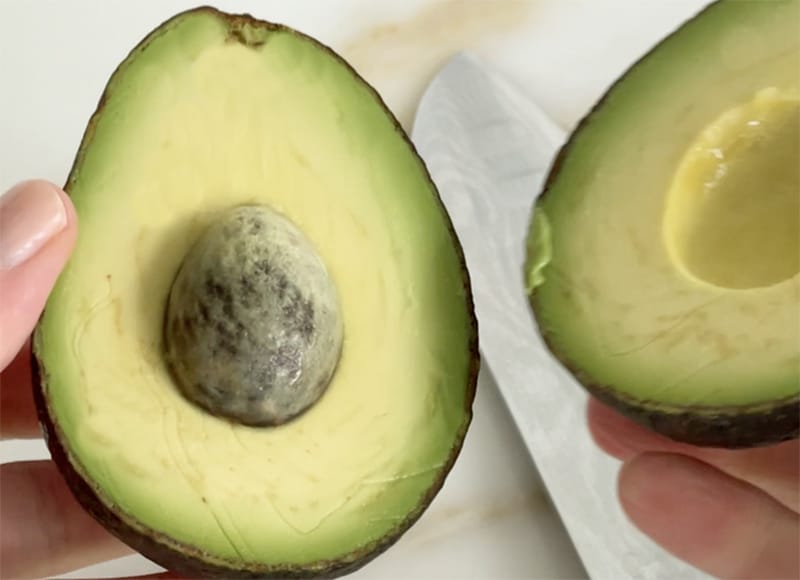 Halved avocado with the pit