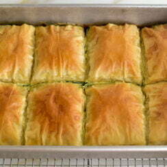 Easier spanakopita with golden cut pieces in a pan