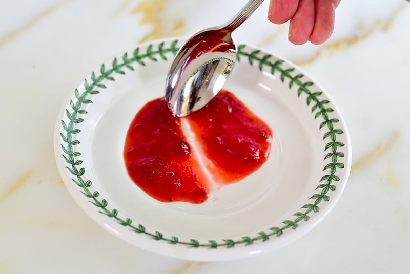 Easy Strawberry Jam on a plate with a spoon