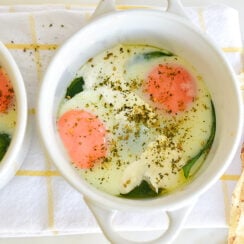 Baked eggs with zaatar in coquette ramekin baking dishes with pita