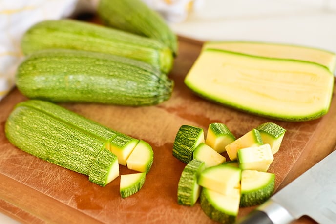 Summer squash on a cutting board cut in wedges