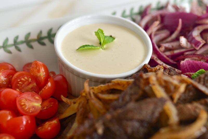 Tahini sauce in a dish for beef shawarma