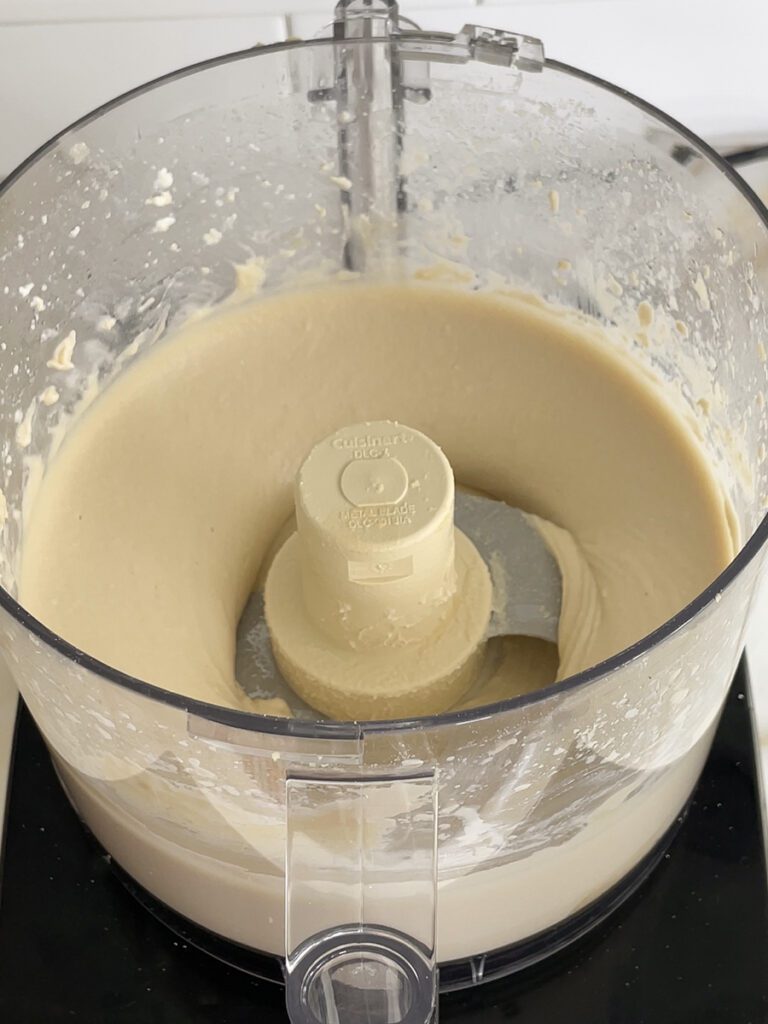 Smooth hummus in the bowl of the food processor