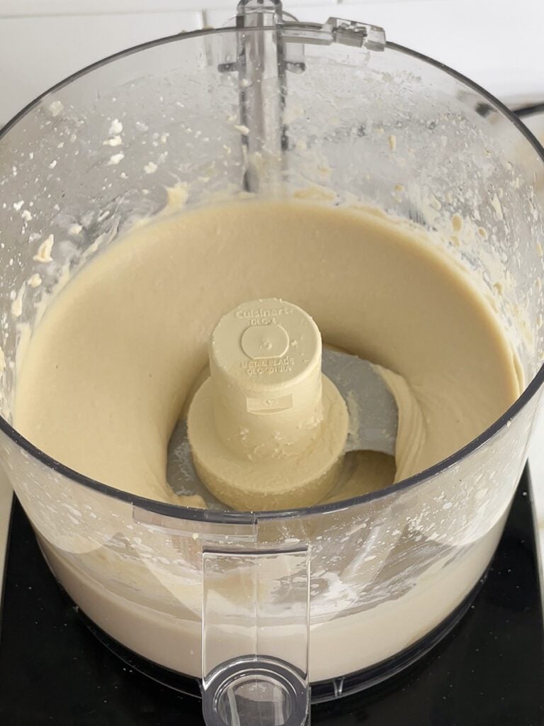 Smooth hummus in the bowl of the food processor.