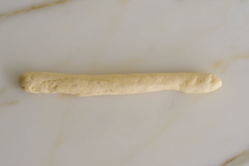 Dough shaped in a log on the counter