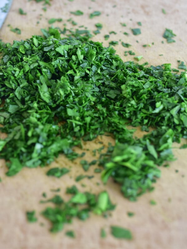 Chopped parsley on a board with a knife