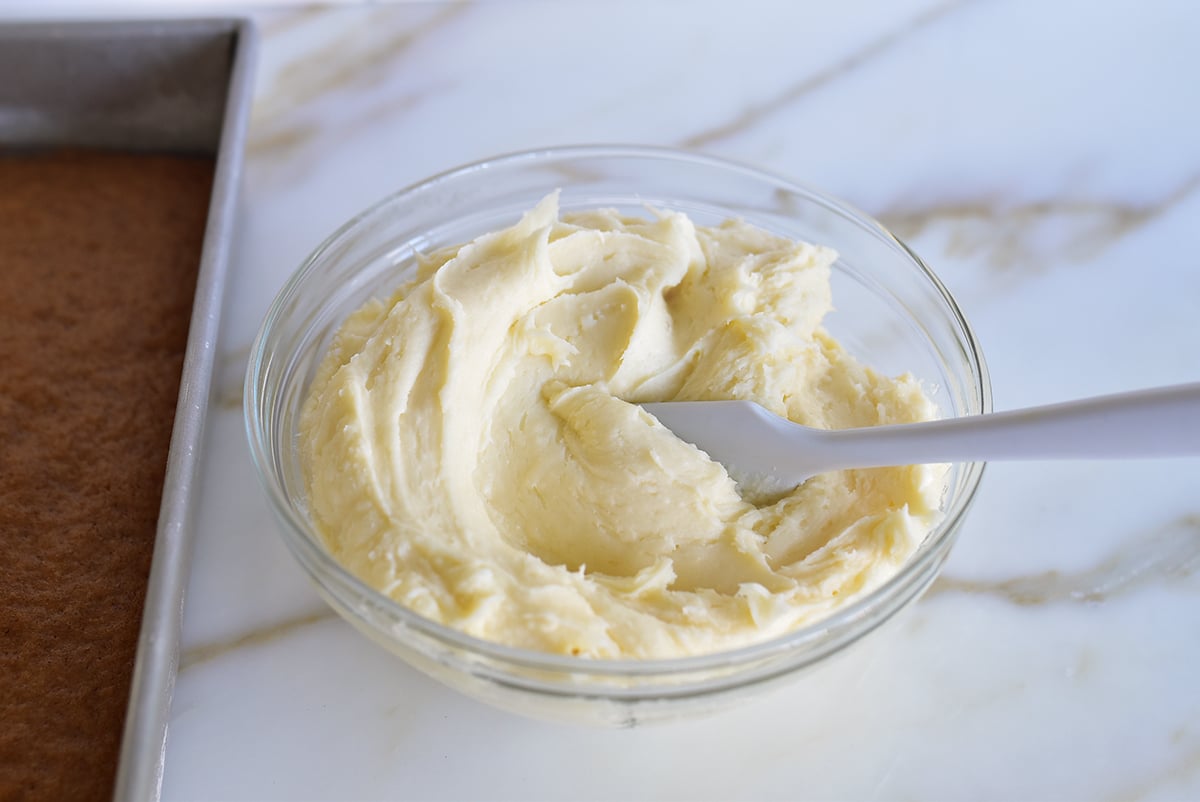 Cream cheese frosting in a bowl with a spatula