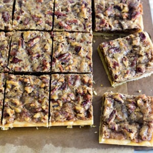 Pecan bars cut in squares with a knife beside them