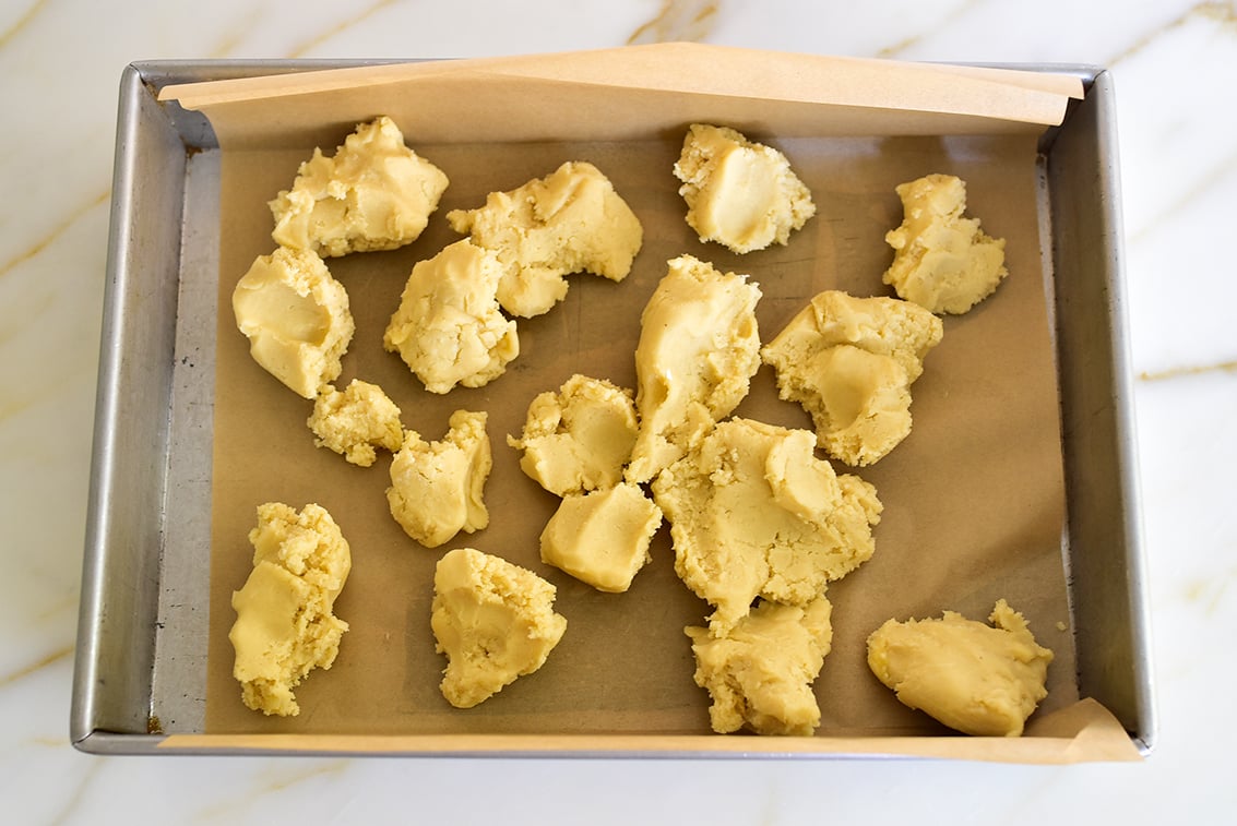 pie crust dough scattered over parchment in a pan