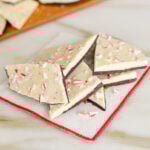 Peppermint bark with white chocolate and crushed candy canes on a red-tipped napkin