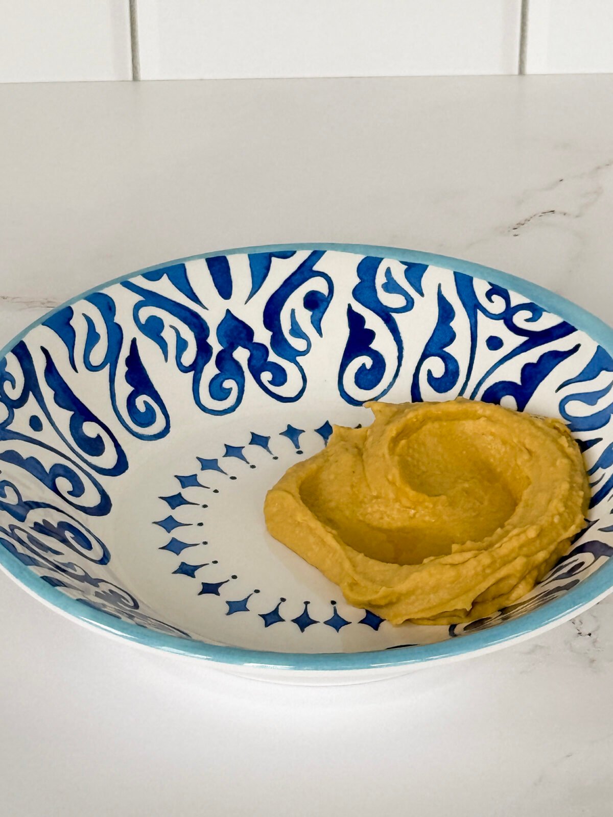 Blue and white bowl with hummus 