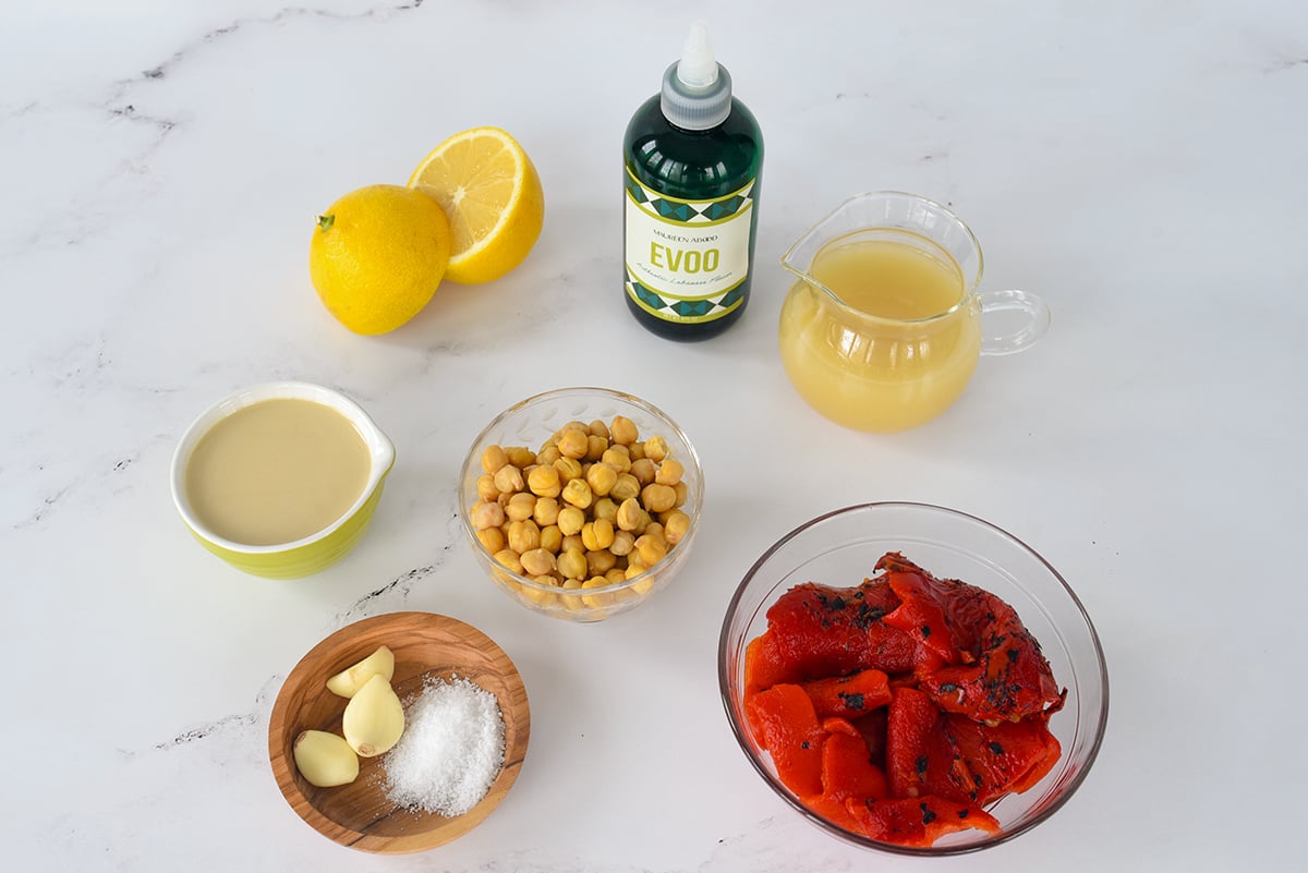 Ingredients for red pepper hummus on a marble countertop