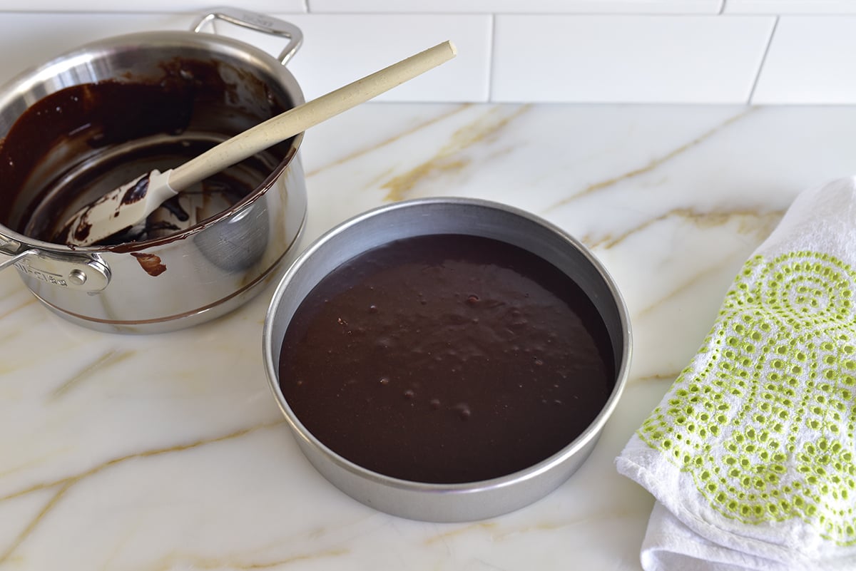 chocolate cake batter in a round pan