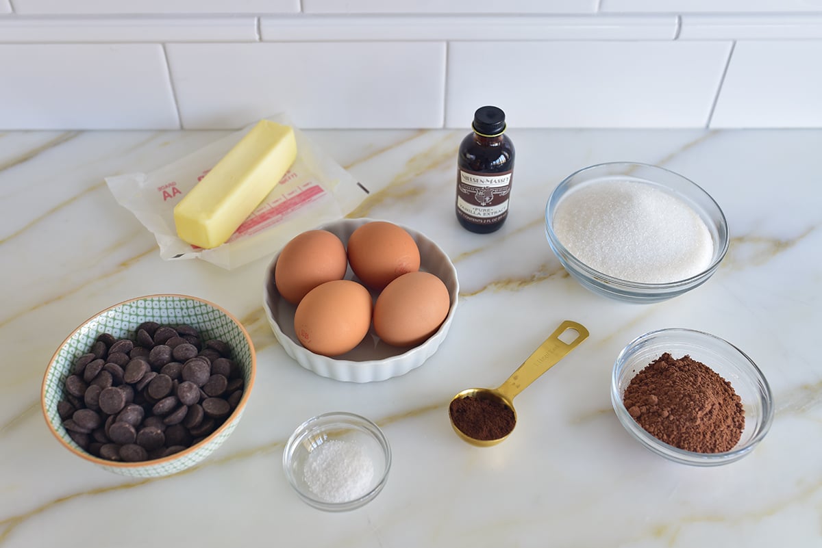 ingredients for flourless chocolate cake on a marble countertop