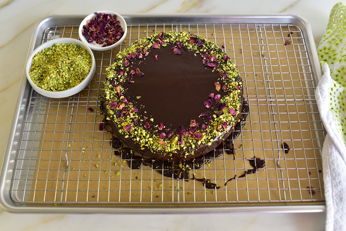 chocolate cake decorated with pistachios and rose petals