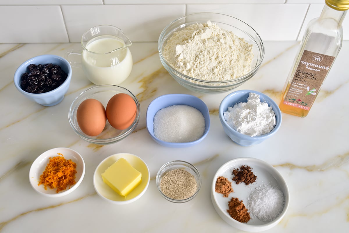 Ingredients for hot cross buns on a marble countertop