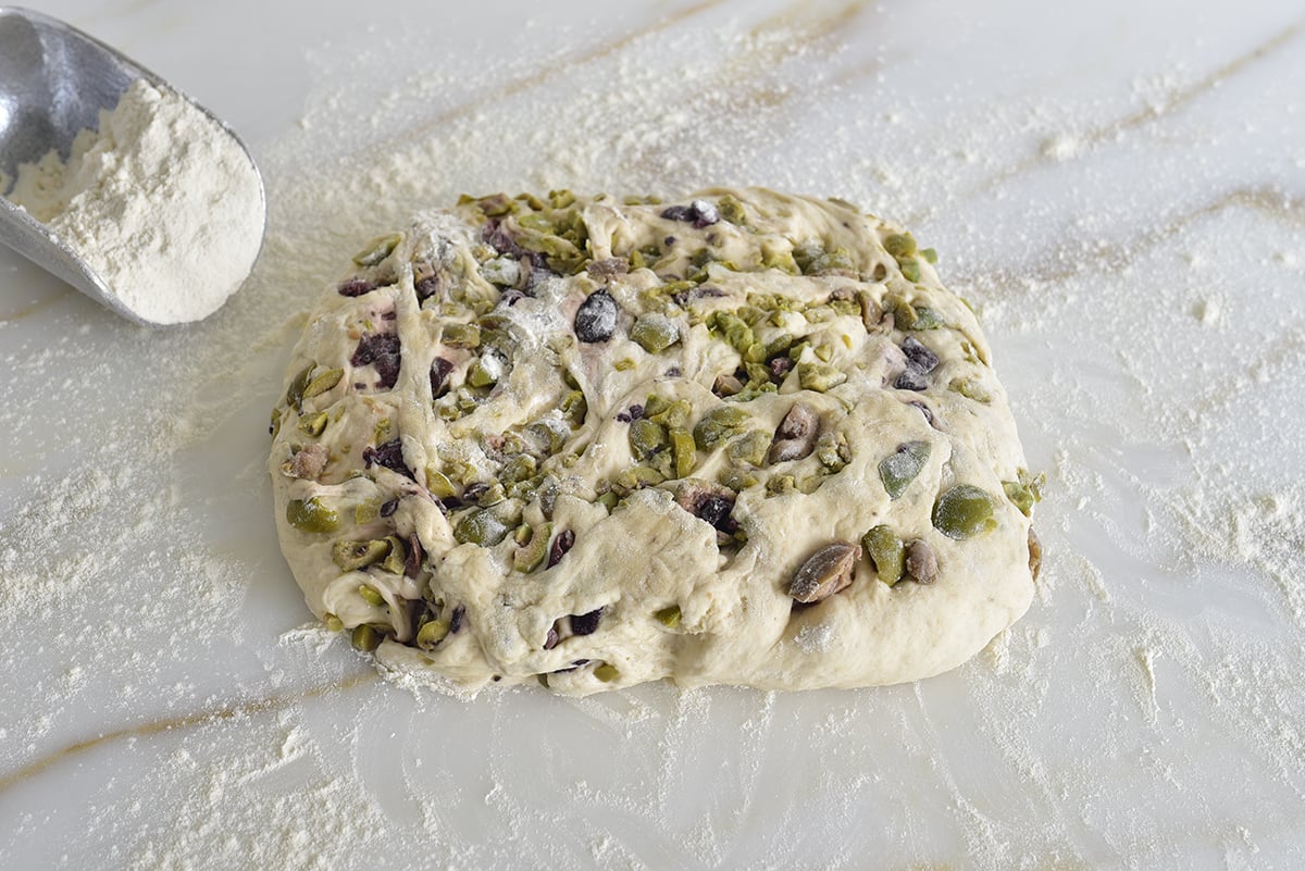 Dough on a marble counter with flour shaped in a square